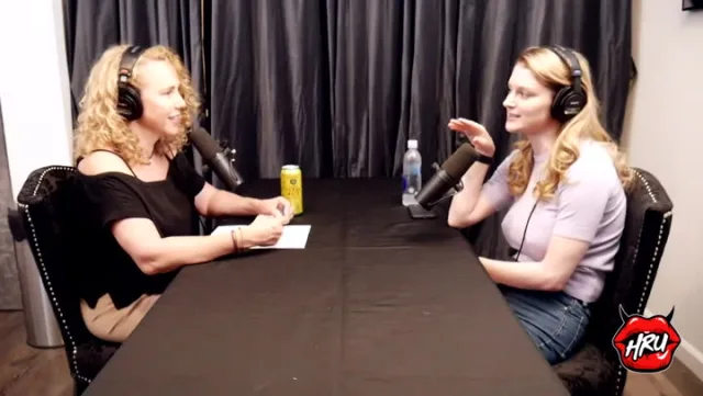 Bunny Colby (right) in a podcast interview, lavender tee and jeans