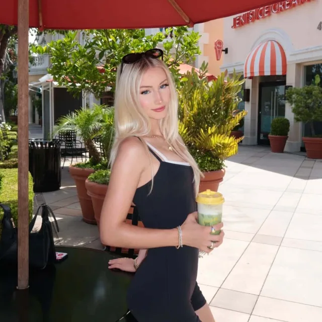 Bella Rome in a black dress outdoors