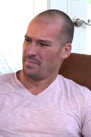 Sean Lawless in a pink tee indoors