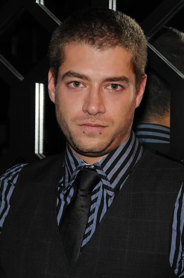 Xander Corvus in a striped shirt, tie and vest