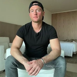 Zac Wild in a black tee and jeans